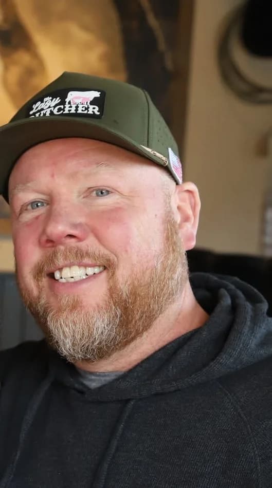 Scott McKenzie, COO of Black Hat Cattle Co. and The Lazy Butcher, wearing a Lazy Butcher cap
