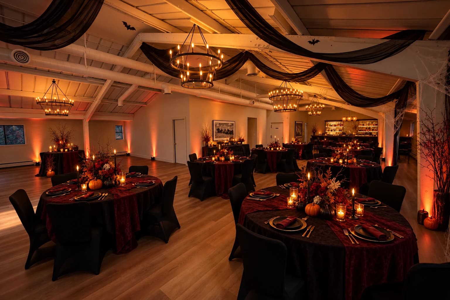 Heritage Hall decorated for Halloween with black draping, pumpkins, and candlelight
