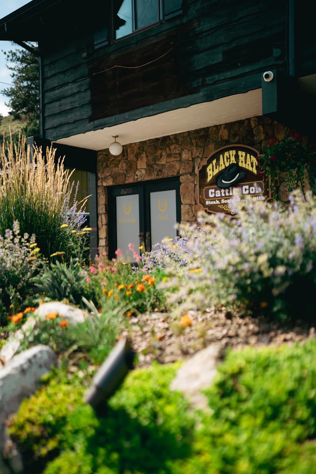 Black Hat Cattle Co. and Heritage Hall exterior entrance in Kittredge, Colorado.