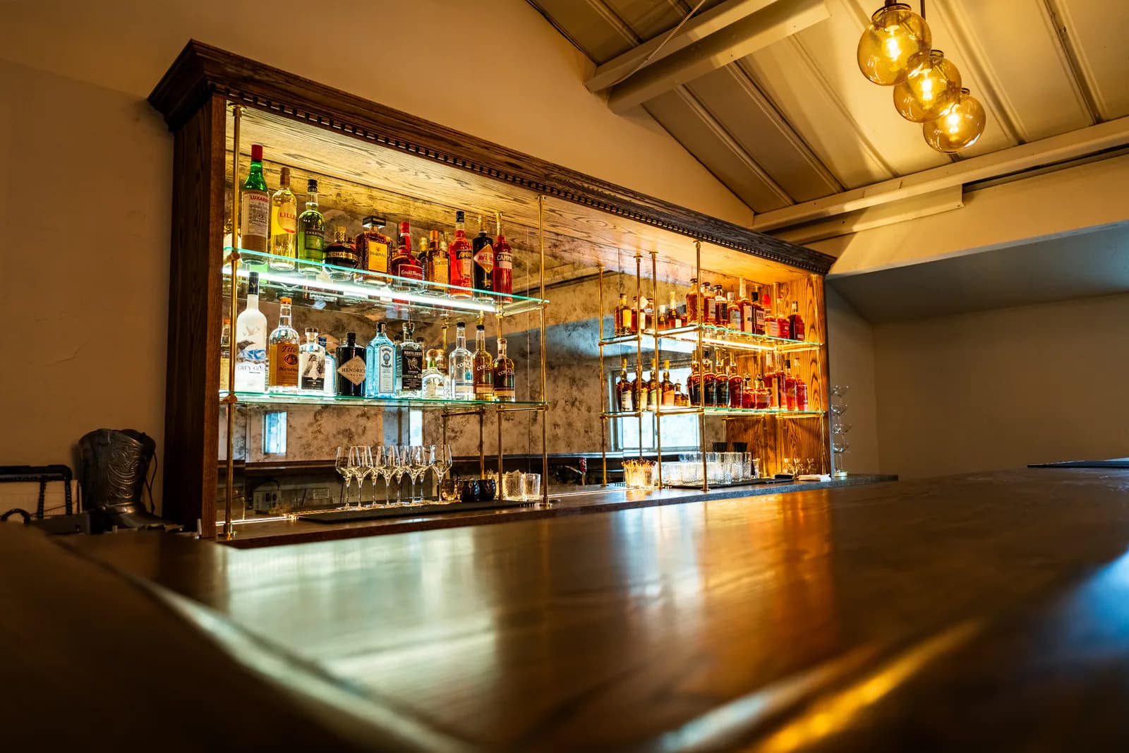 Velvet Brim bar built into Heritage Hall with backlit bottles.