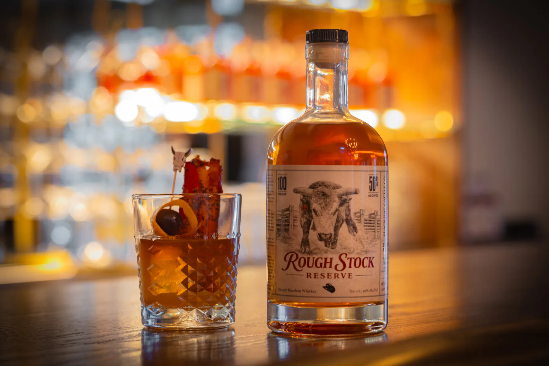 Old Fashioned cocktail and Rough Stock whiskey bottle on the Velvet Brim bar.