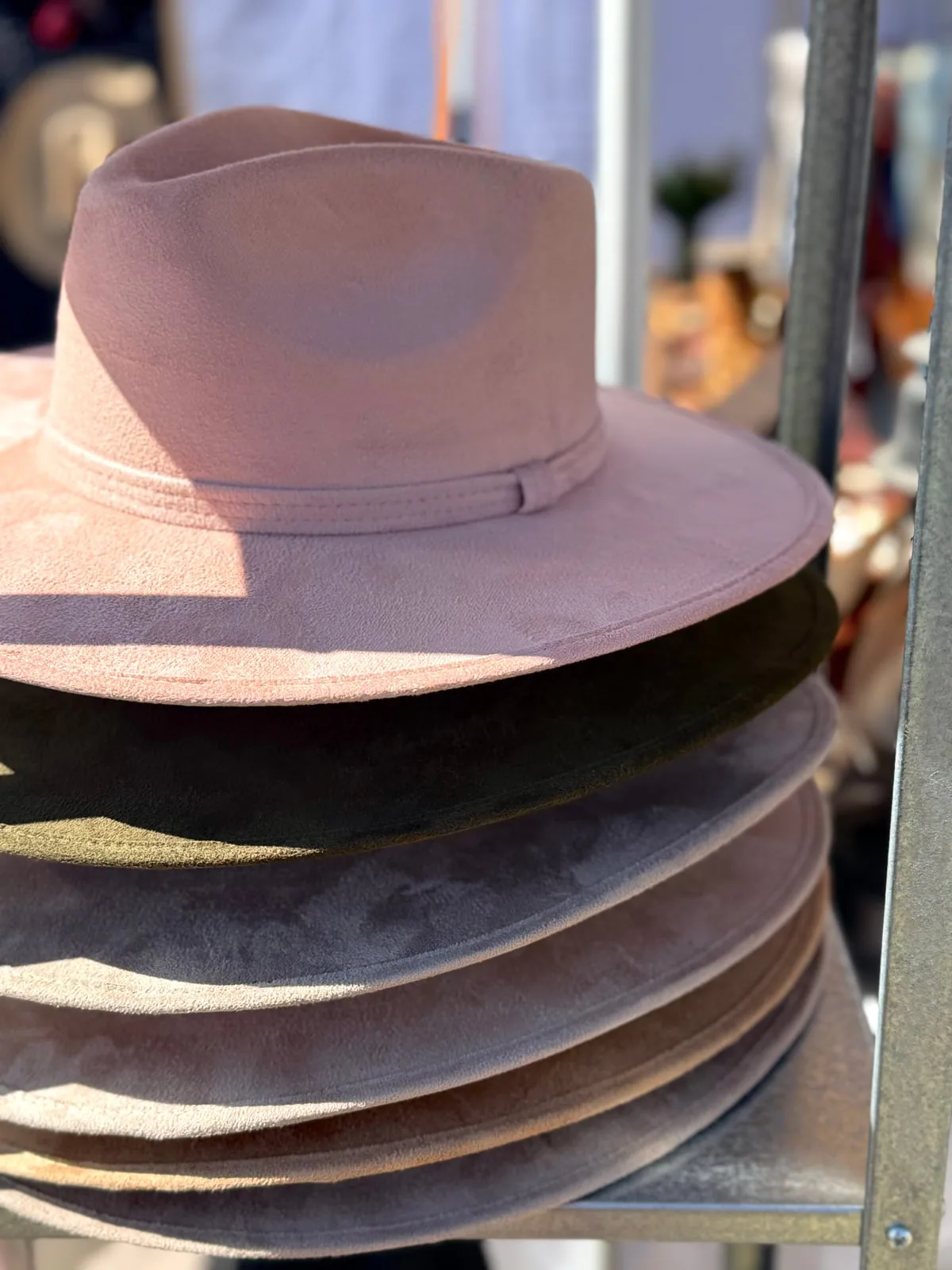Choose your starting shape, then build the details from there. Stack of soft western hat blanks in blush, gray, and cream tones